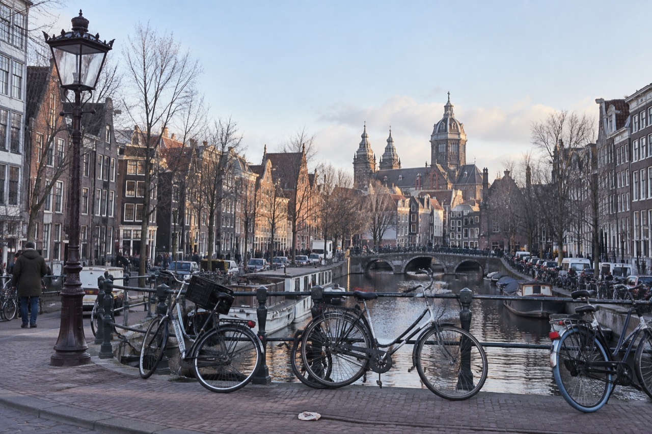 Amsterdam canal houses and bicycles along a quiet gracht in the early morning