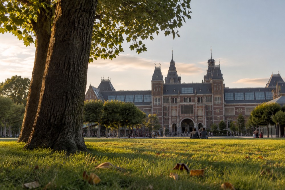 The facade of the Rijksmuseum seen across a green lawn in the Museum Quarter