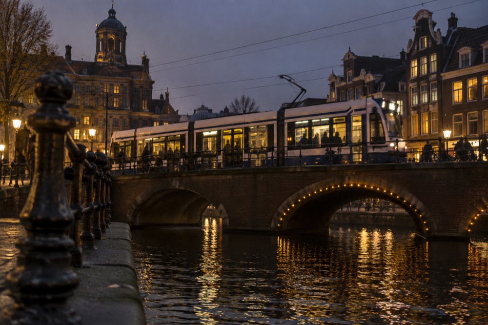 A tram crossing a canal bridge in the Amsterdam city centre