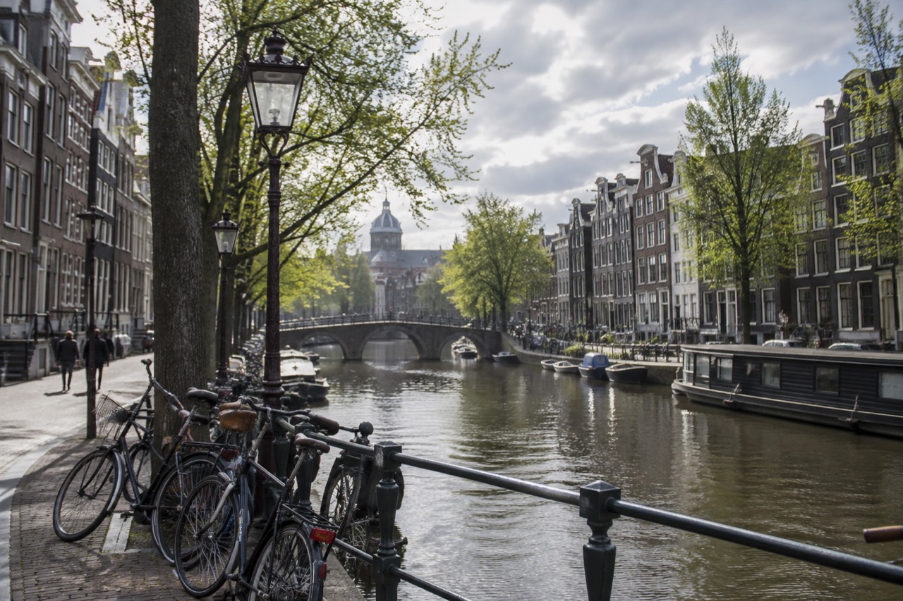 Canal houses and bicycles along a quiet Amsterdam street