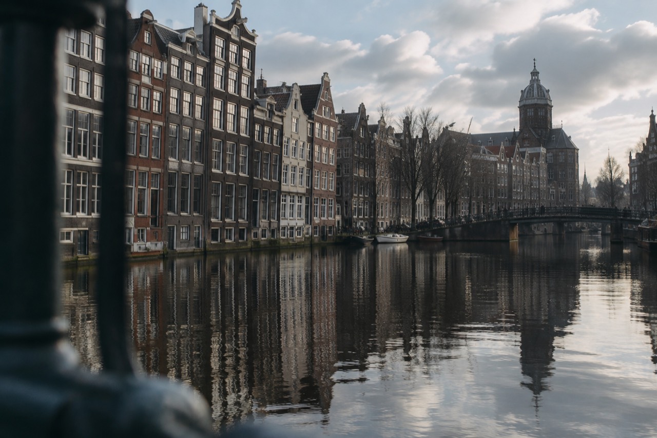 Amsterdam canal houses reflected in still winter water on a quiet January morning