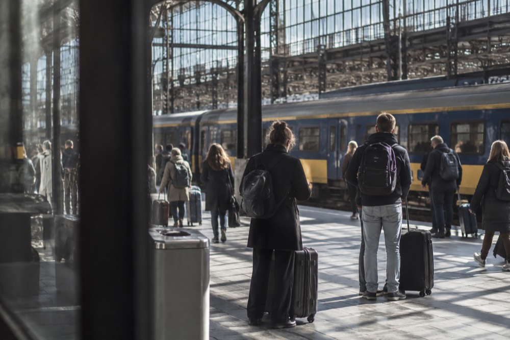 Travellers checking departure boards inside Amsterdam Centraal station