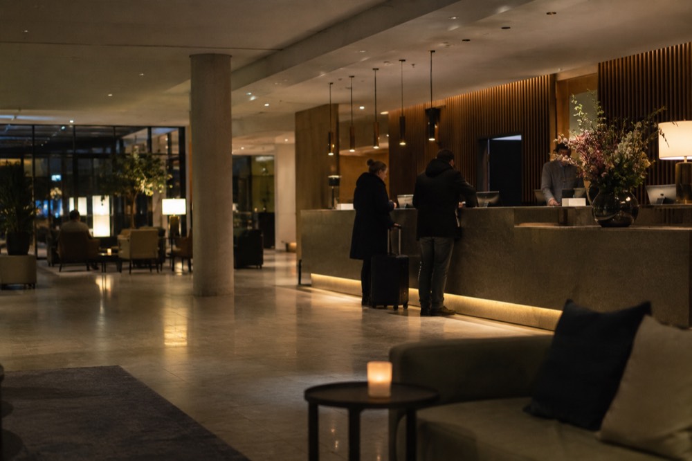 Hotel reception desk in a modern airport hotel lobby with soft evening lighting