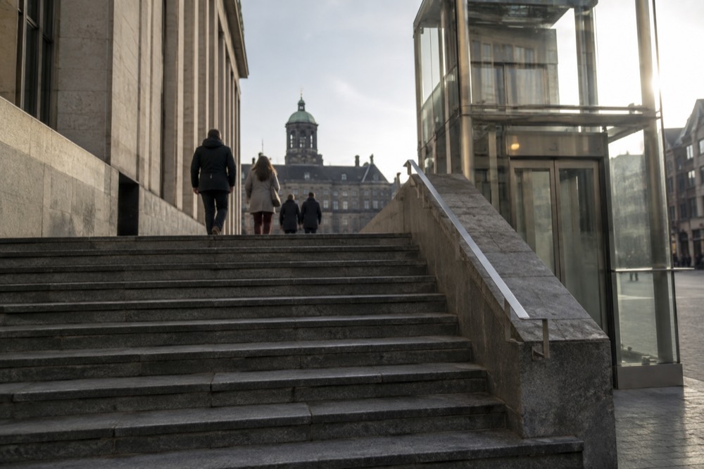 A wide modern museum staircase with a lift beside it in Amsterdam