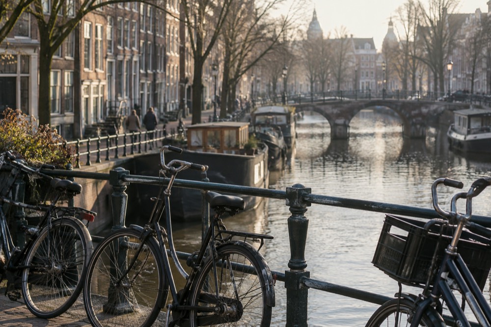 Bicycles parked along a canal bridge in an Amsterdam residential neighbourhood