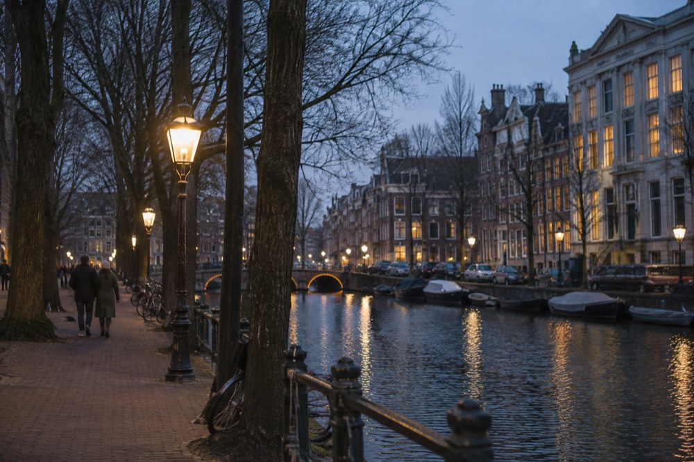 Tree-lined path beside a canal in the Plantage district with 19th-century facades