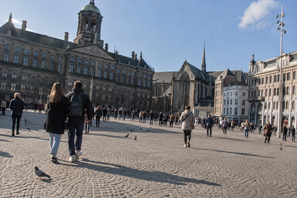 Brick facades and a quiet canal edge beside Dam Square