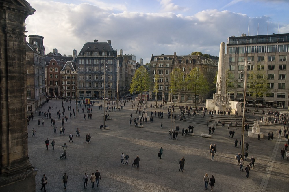 The waterfront near Dam Square under a broad grey northern sky