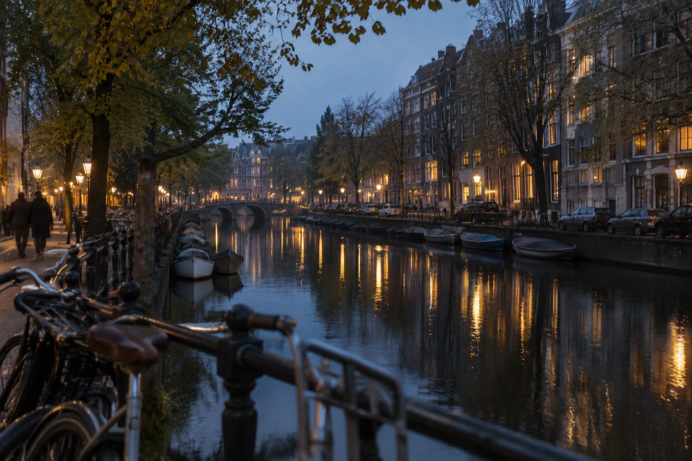 Evening light on a canal in Oud-Zuid with brick houses reflected in the water