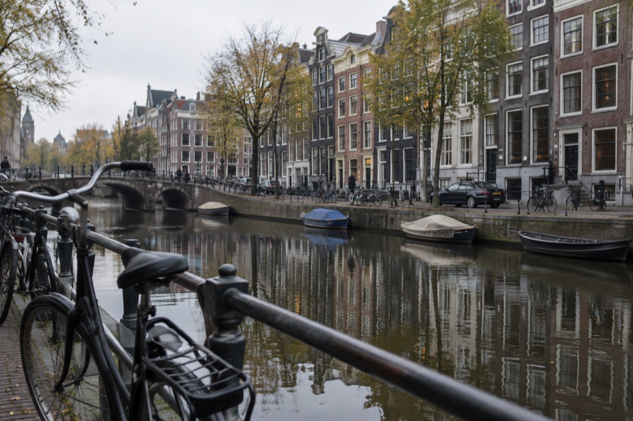 Seventeenth-century canal houses reflected in the water of an Amsterdam gracht