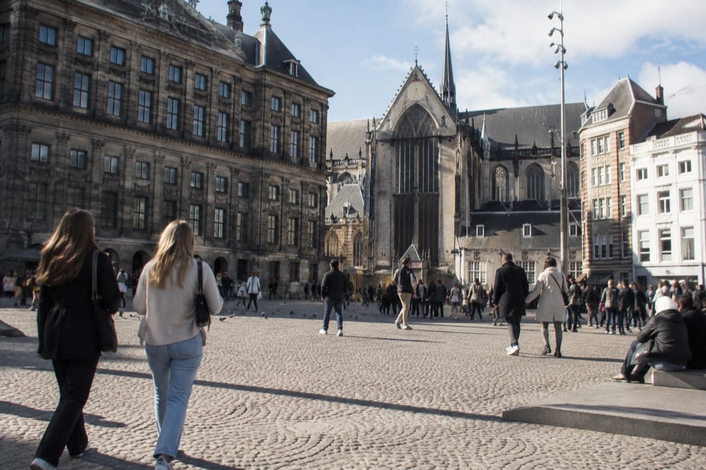 Brick facades and a quiet canal edge beside Dam Square