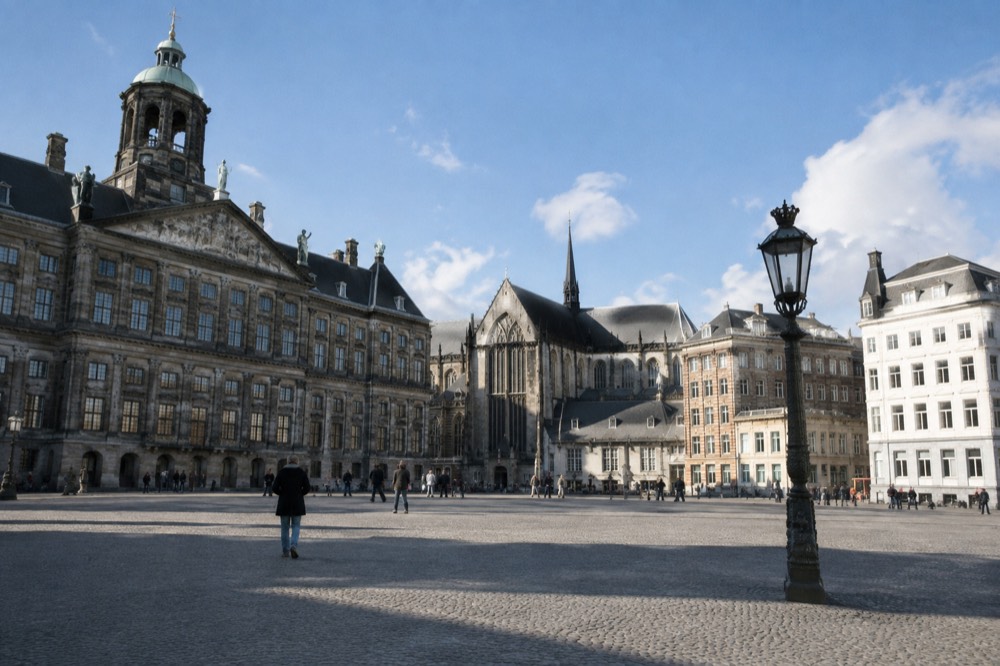 People walking past Dam Square, seen from across the street
