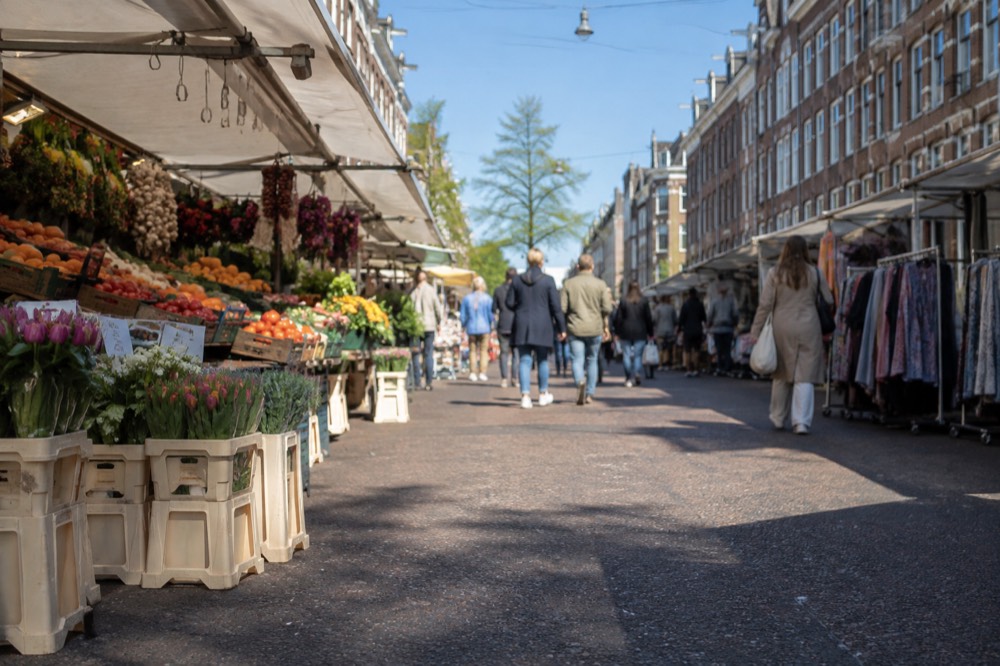 People walking past Albert Cuyp Market, seen from across the street