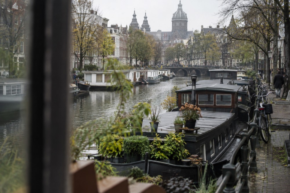 Houseboats moored along the Prinsengracht canal near the Amsterdam Tulip Museum