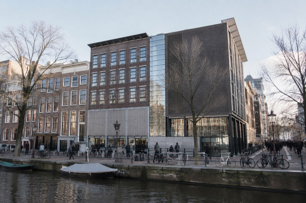 People walking past Anne Frank House, seen from across the street