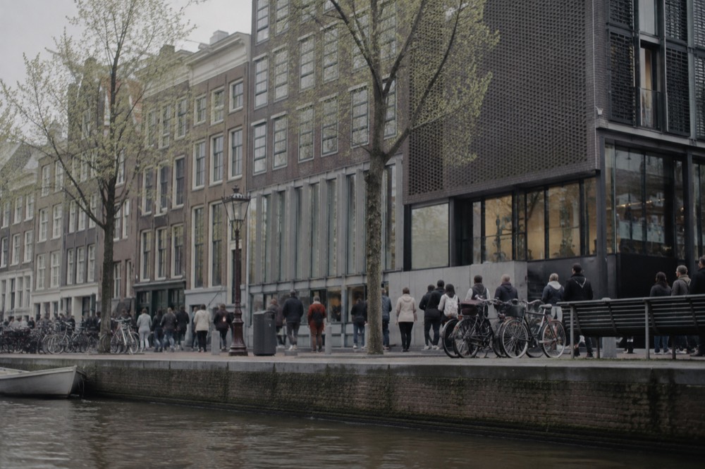 A quiet corner of Anne Frank House with trees overhanging the water