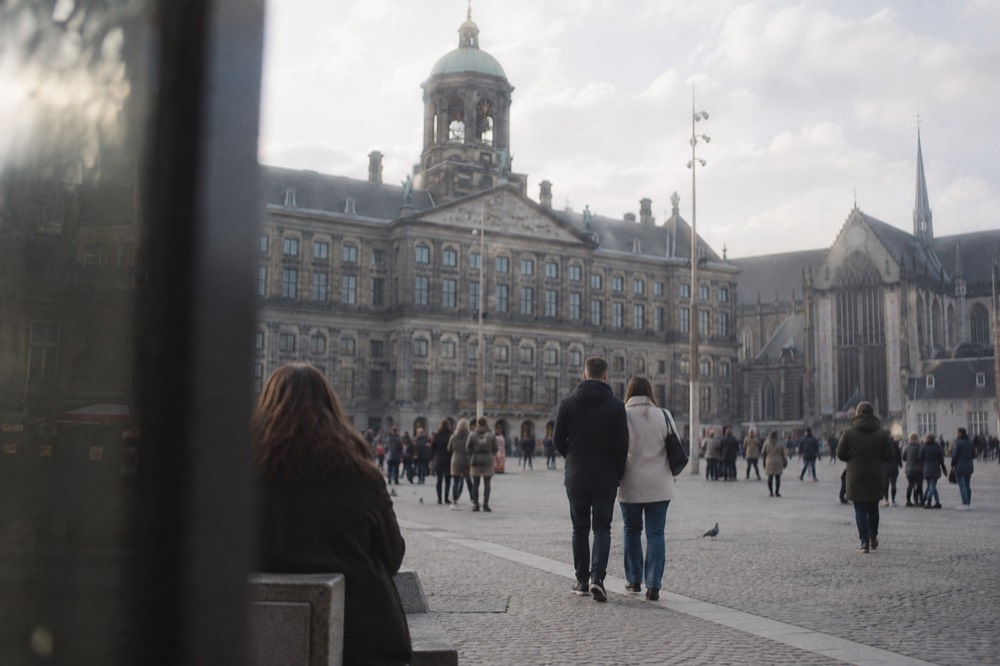 The waterfront near Dam Square under a broad grey northern sky