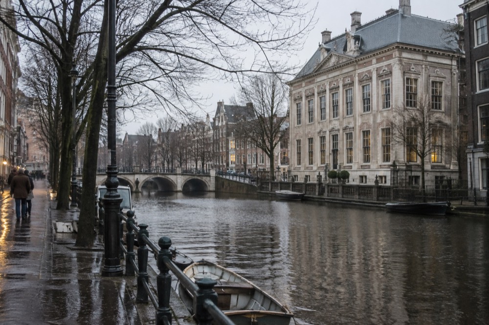 Classical river facade of the Amstelhof building beside the Amstel in Amsterdam