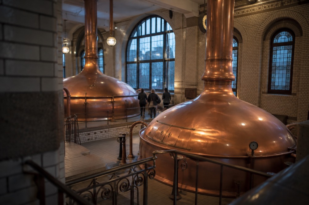 Copper brewing kettles inside the old Heineken brewery hall