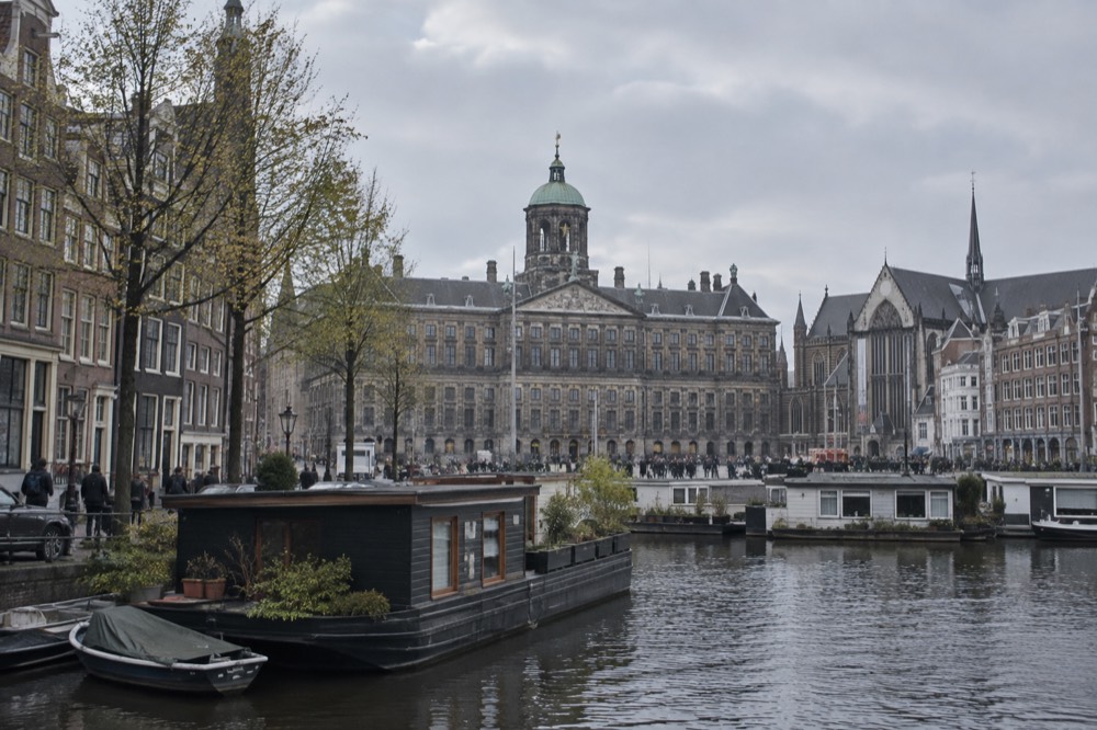 Brick facades and a quiet canal edge beside Dam Square