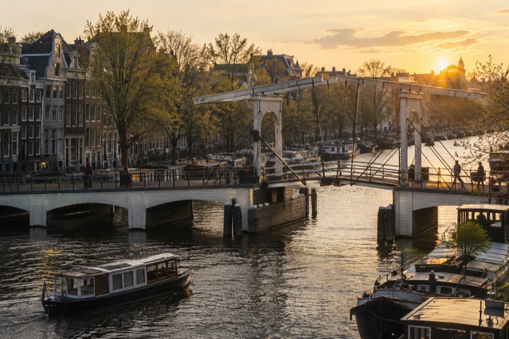 A quiet corner of Magere Brug with trees overhanging the water