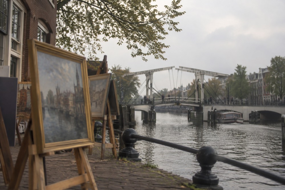 The waterfront near Magere Brug under a broad grey northern sky
