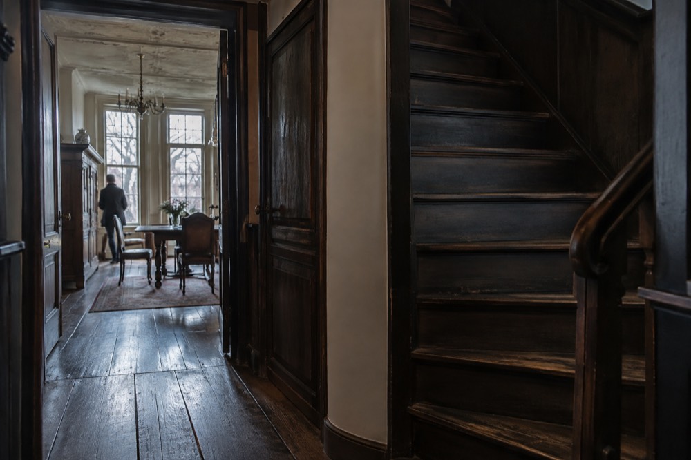 A narrow staircase and period room interior in a 17th-century Amsterdam canal house