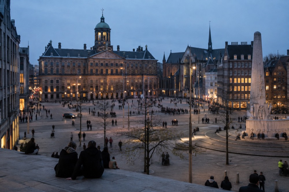 Brick facades and a quiet canal edge beside Dam Square