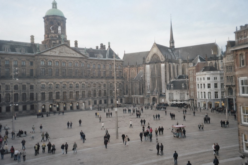 The waterfront near Dam Square under a broad grey northern sky