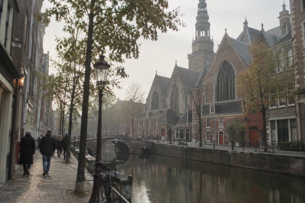 A street-level view of Oude Kerk on an ordinary weekday morning