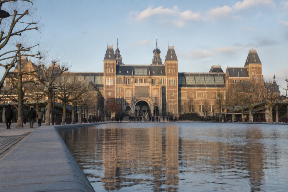 The Rijksmuseum facade seen from Museumplein with the pond in the foreground