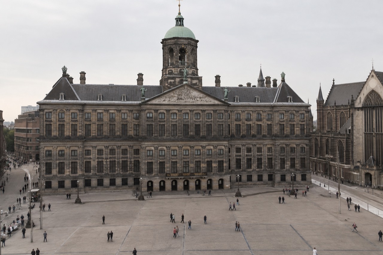 View of a grand classical building on a paved square with a clear sky