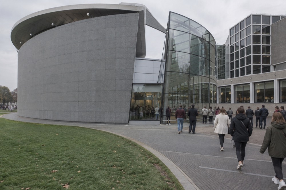 People walking past Van Gogh Museum, seen from across the street