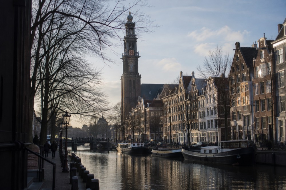 The Westerkerk tower rising above the gabled houses along the Prinsengracht canal