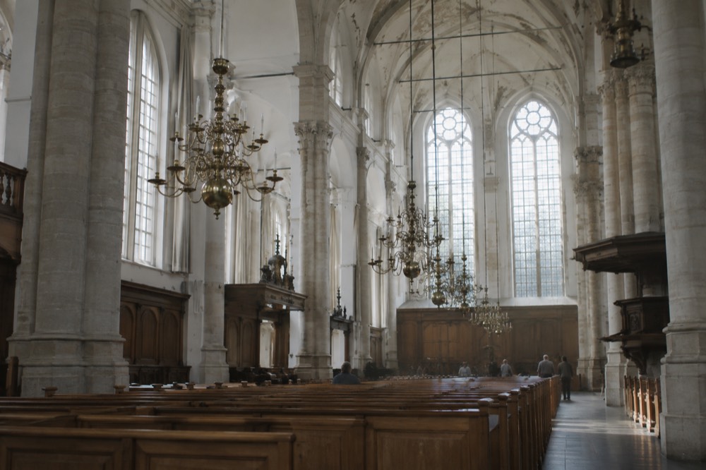 The Westerkerk church interior with tall arched windows and pale stone columns