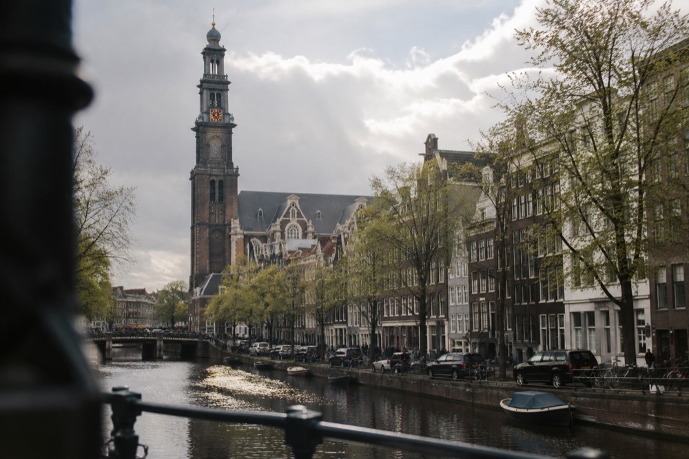 The waterfront near Westerkerk under a broad grey northern sky