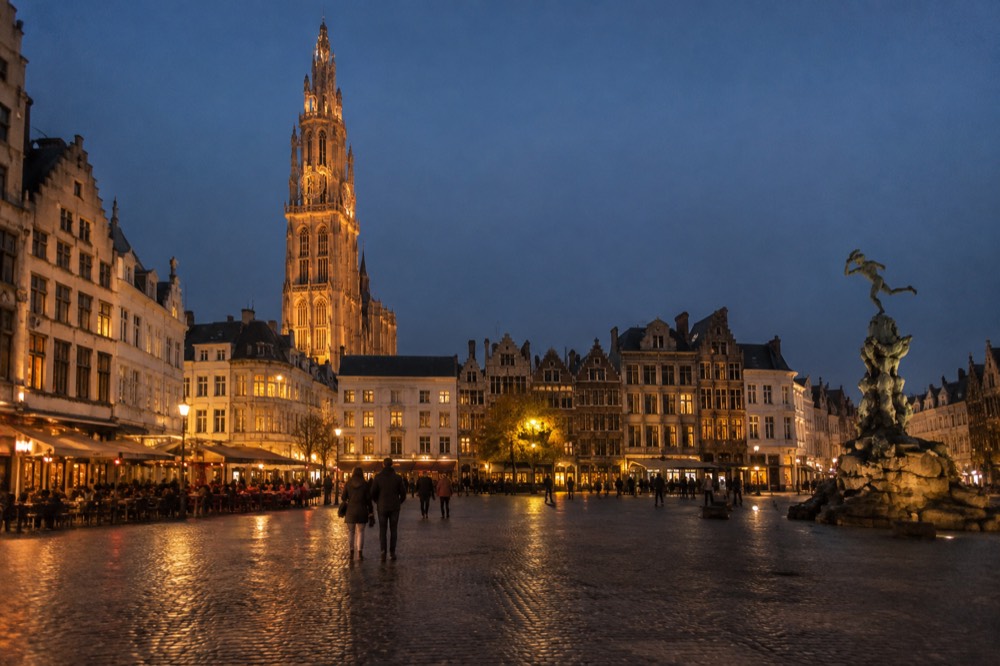 Brick facades and a quiet canal edge beside Antwerp