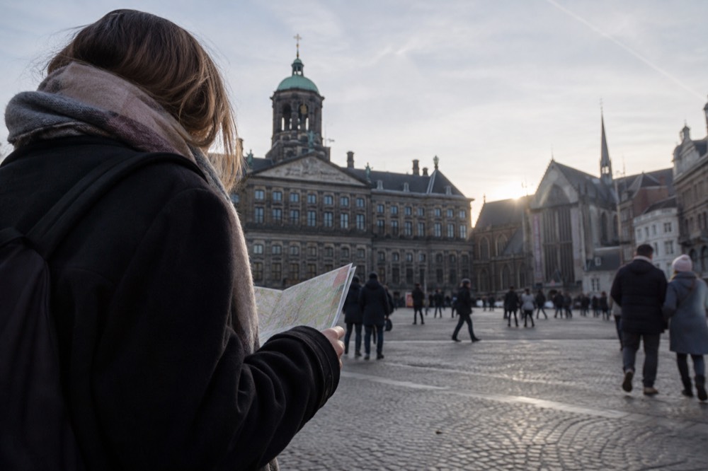 People walking past Dam Square, seen from across the street