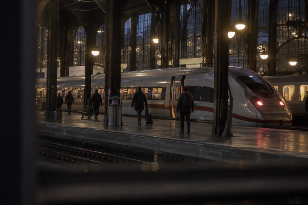 High-speed train waiting at a platform in a large European railway station