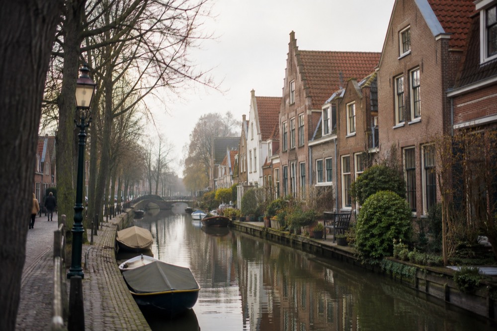 A row of narrow gabled houses beside a canal in Edam