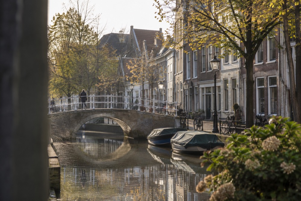 A canal bridge and moored boats close to Gouda