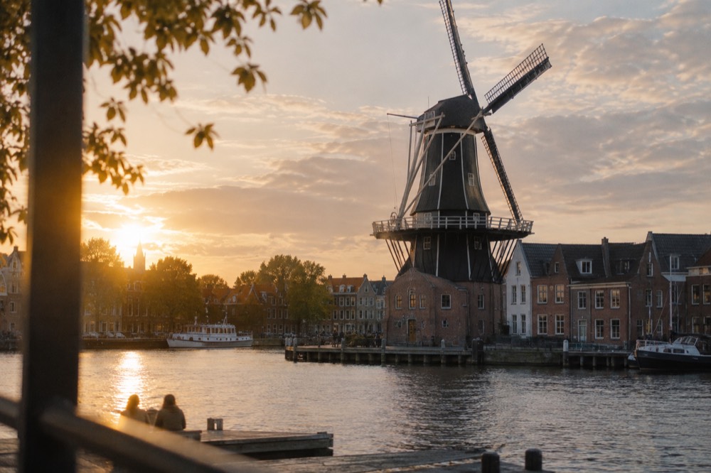 The Molen de Adriaan windmill standing on the bank of the river Spaarne