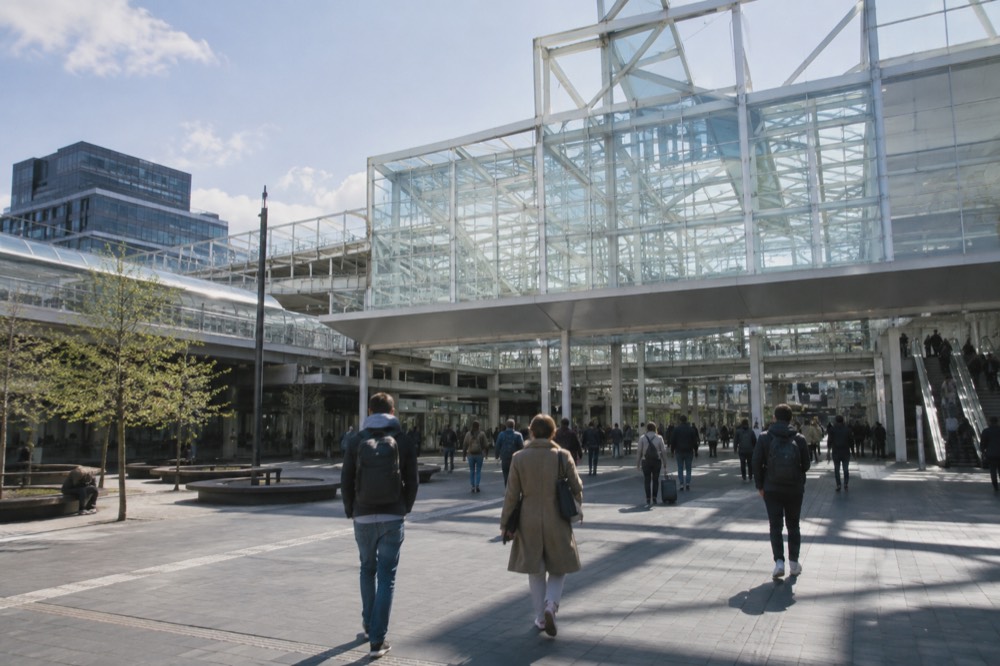 The modern station hall at Leiden Centraal with travellers heading toward the city centre