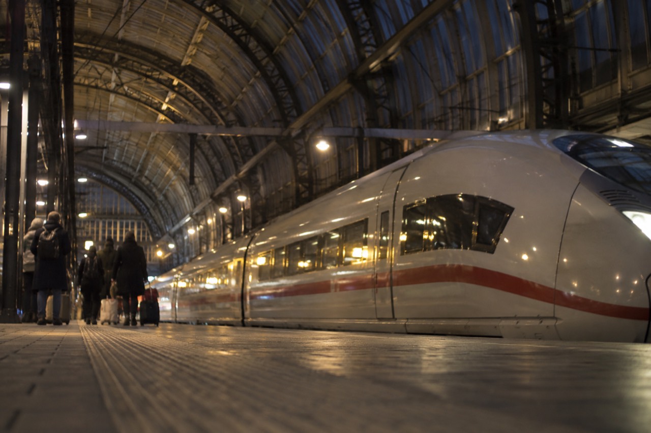A high-speed train platform at Amsterdam Centraal Station with the station roof above the tracks