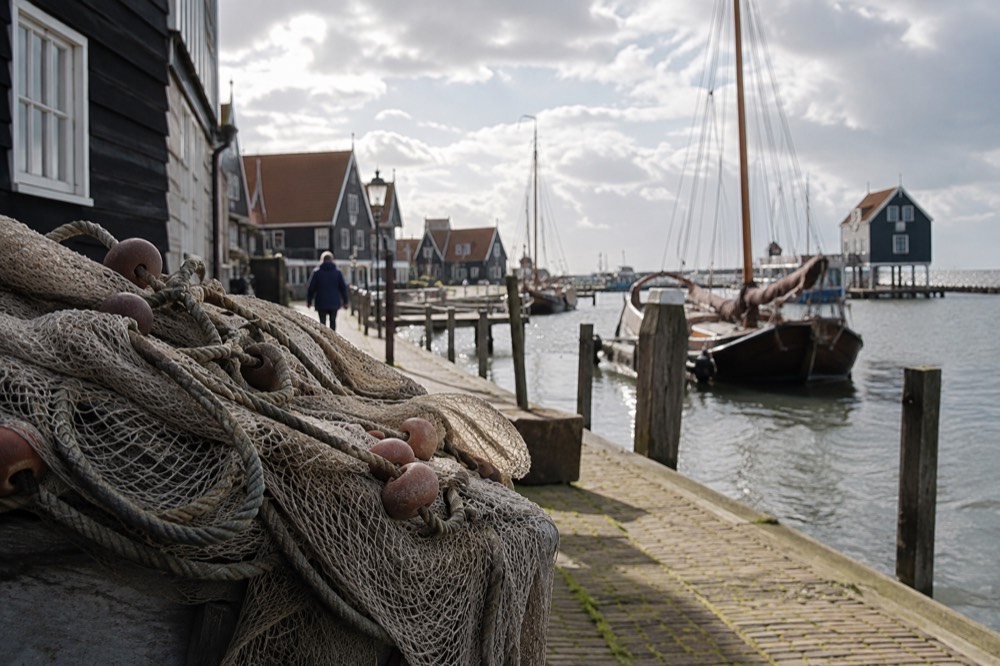 A quiet corner of Volendam with trees overhanging the water