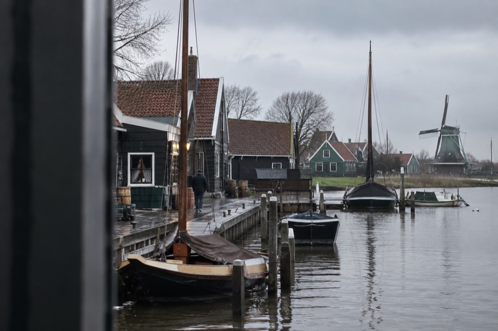 Harbour of a Dutch fishing village with wooden houses and small boats along the waterfront