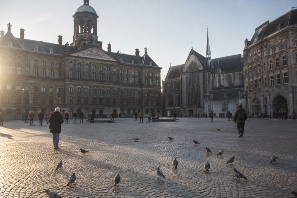 A canal bridge and moored boats close to Dam Square