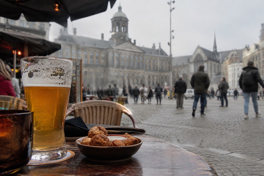The waterfront near Dam Square under a broad grey northern sky