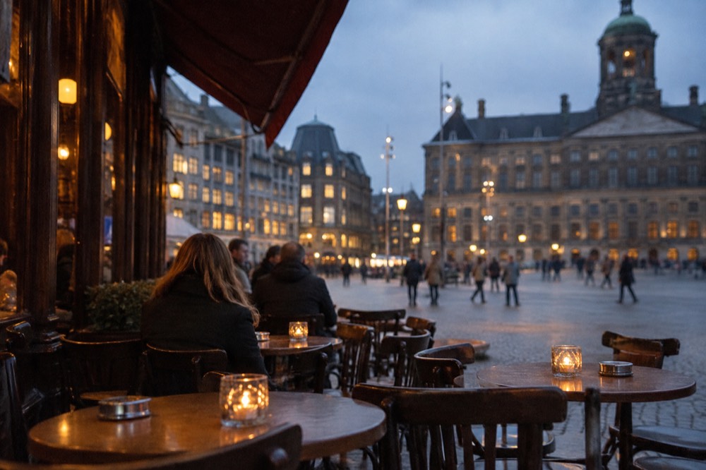 Brick facades and a quiet canal edge beside Dam Square
