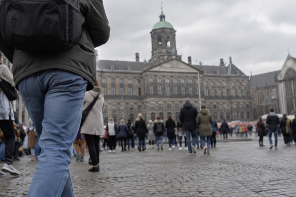 Brick facades and a quiet canal edge beside Dam Square